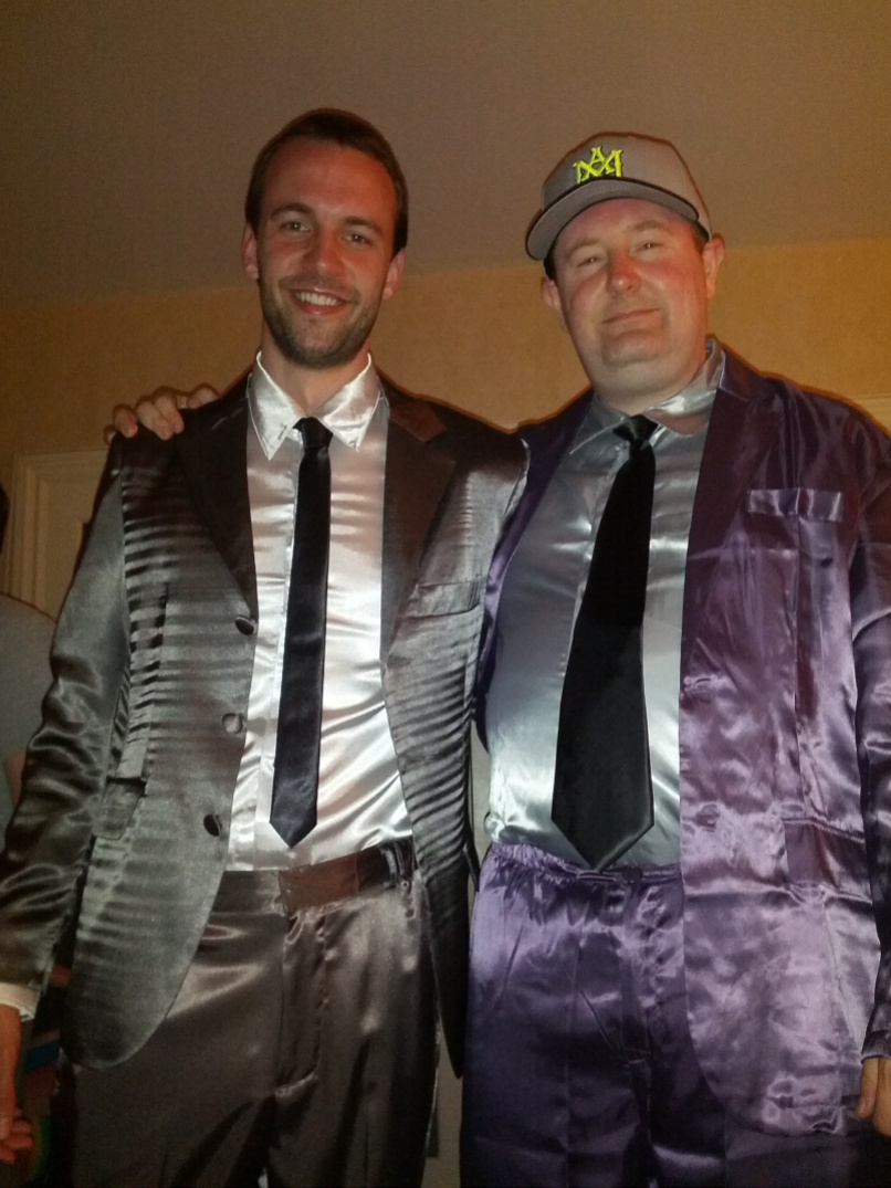 Two guys wearing SuitJamas at a pajama party.